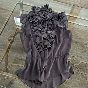 Fun sleeveless top with lots of ruffles top can be tied or left open by the neck